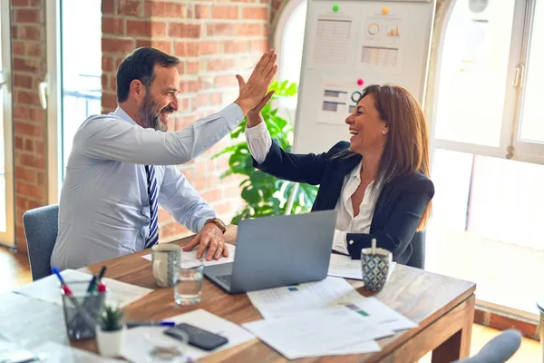 Two colleagues celebrating a successful meeting